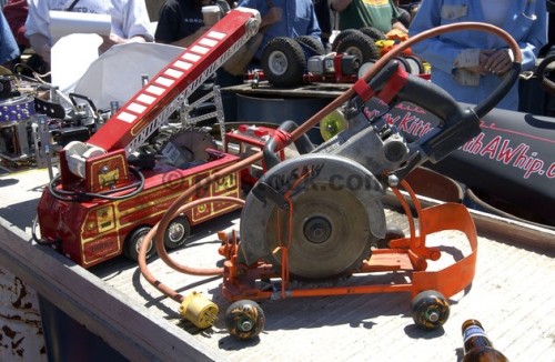 For the third consecutive year, mechanic enthusiasts gathered in a San Francisco junkyard with their modified power tool machines to race side-by-side down a 75-foot wooden track. Most machines, attached to electrical cords, were based on common power tools such as circular saws, grinders, drills and belt sanders fitted with wheels. While most contestants competed for fun and for the underground type atmosphere, some hoped to win the $1,000 final grand prize.