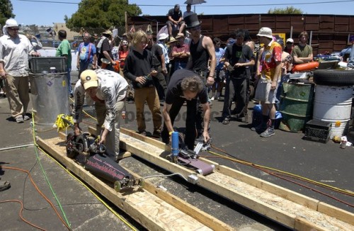 Contestants get ready at the start line with their power tool racing machines in the Power Tool Drag Races in San Francisco on June 13, 2004. For the third consecutive year, mechanic enthusiasts gathered in a San Francisco junkyard with their modified power tool machines to race side-by-side down a 75-foot wooden track. Most machines, attached to electrical cords, were based on common power tools such as circular saws, grinders, drills and belt sanders fitted with wheels. While most contestants competed for fun and for the underground type atmosphere, some hoped to win the $1,000 final grand prize.