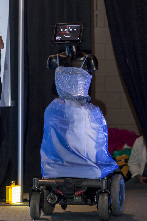 AUSTIN, TEXAS - MAY 7, 2016: Annabelle of Bot Party, a robotic comedy theatre troupe, models clothing during the Fashion Show at the 2016 Maker Faire in Austin, Texas.